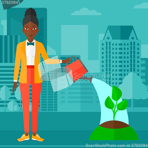 Image of Woman watering tree.