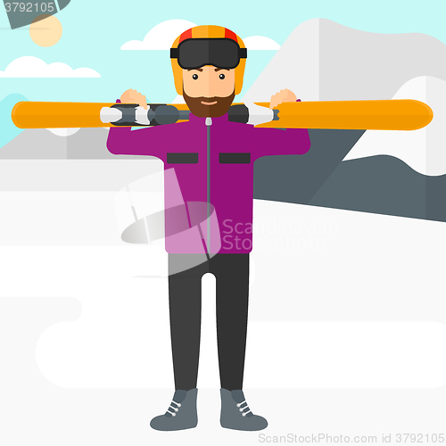 Image of Man holding skis.
