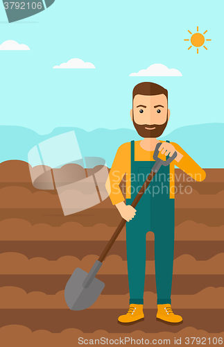 Image of Farmer on the field with shovel.