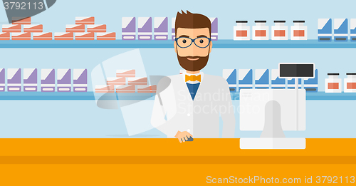 Image of Pharmacist at counter with computer monitor.