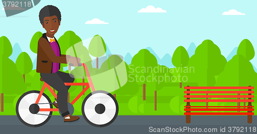Image of Man riding bicycle.