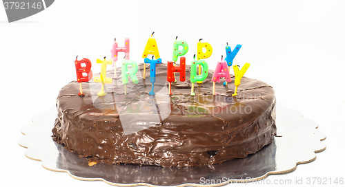 Image of Chocolate happy birthday cake on silver tray towards white