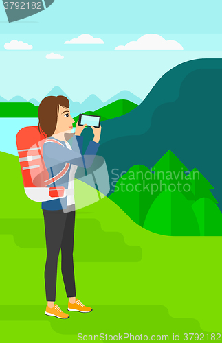 Image of Backpacker taking photo.