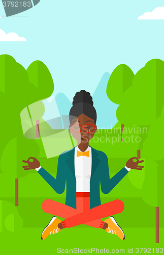 Image of Business woman meditating in lotus pose.