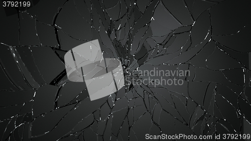 Image of Pieces of splitted or cracking glass on black