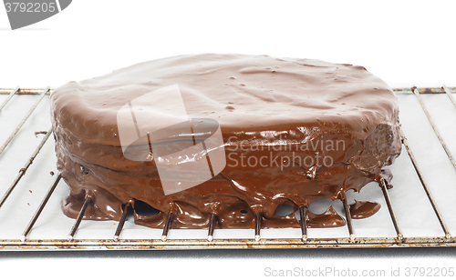 Image of Chocolate icing dripping off from freshly made sacher torte cake