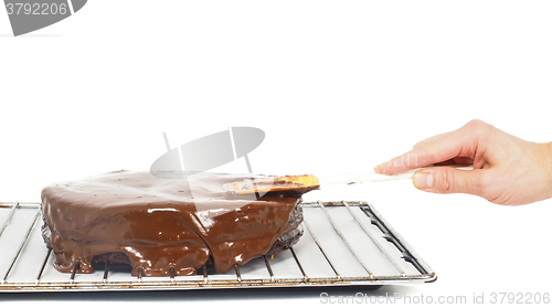 Image of Pastry chef making final touches to a sacher chocolate cake with