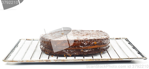 Image of Half stage on sacher torte chocolate cake on grid before chocola