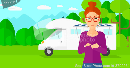 Image of Woman standing in front of motor home.