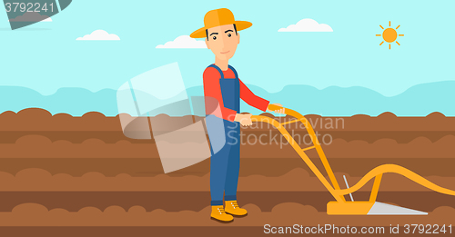 Image of Farmer on the field with plough.