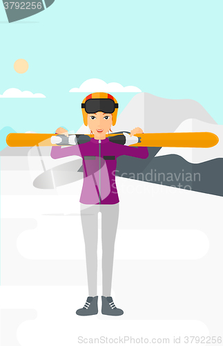 Image of Woman holding skis.