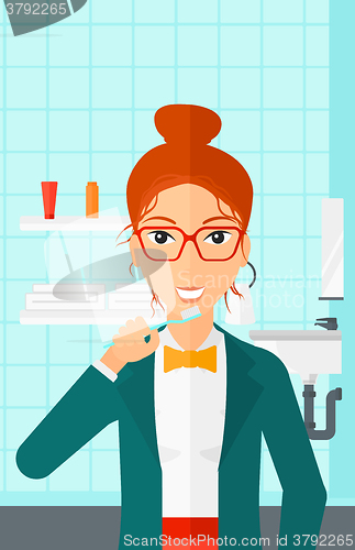 Image of Woman brushing teeth.