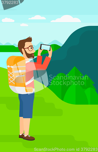 Image of Backpacker taking photo.