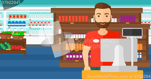 Image of Salesman standing  at checkout.