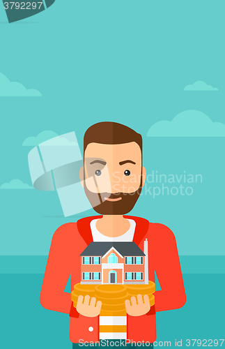 Image of Man holding house model.