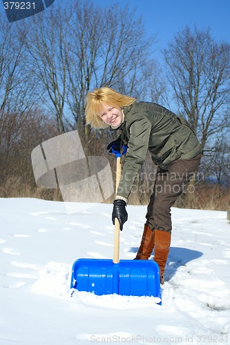 Image of Woman shoveling after a snow storm