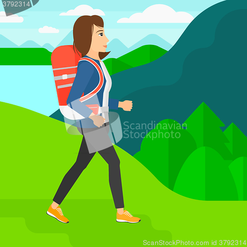 Image of Woman with backpack hiking.