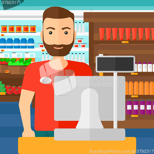 Image of Salesman standing  at checkout.