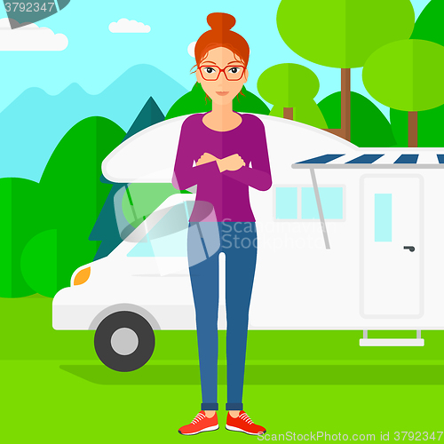 Image of Woman standing in front of motor home.