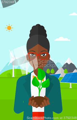 Image of Woman holding plant.