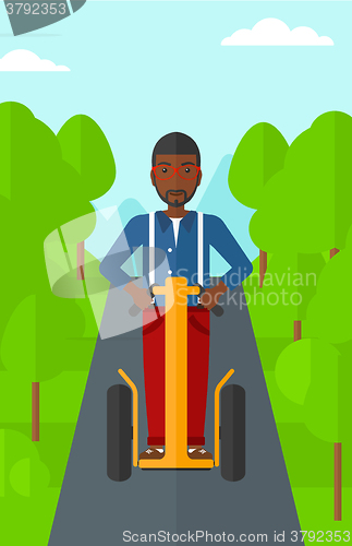 Image of Man riding on electric scooter.