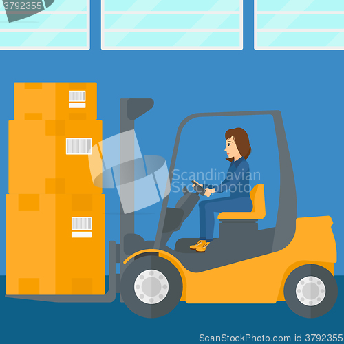 Image of Warehouse worker moving load by forklift truck.