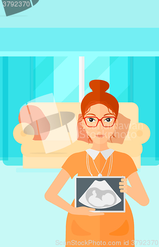 Image of Pregnant woman with ultrasound image.