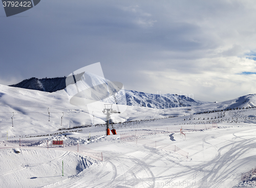 Image of Ski slope with surface lift and gray sky