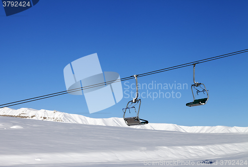 Image of Chair-lift and blue clear sky at sun day
