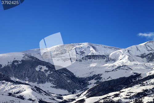 Image of Snowy sunlight mountains at sun morning