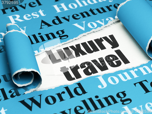 Image of Tourism concept: black text Luxury Travel under the piece of  torn paper