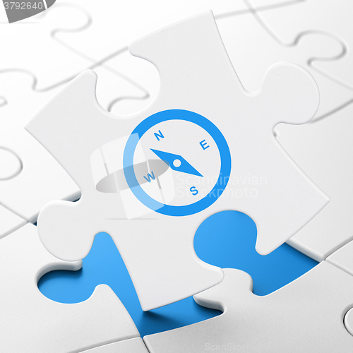 Image of Tourism concept: Compass on puzzle background