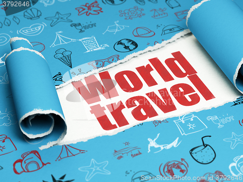 Image of Vacation concept: red text World Travel under the piece of  torn paper