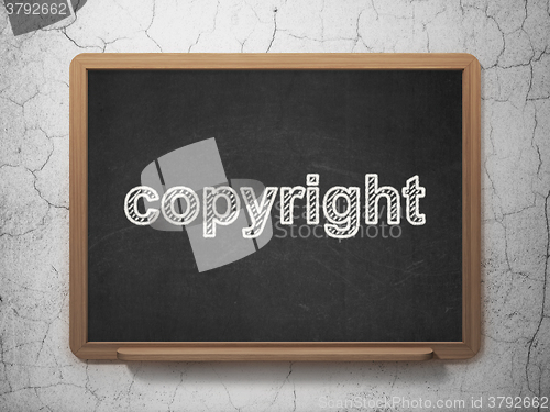 Image of Law concept: Copyright on chalkboard background