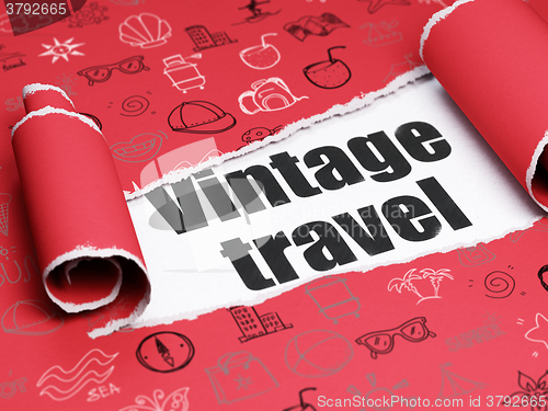 Image of Travel concept: black text Vintage Travel under the piece of  torn paper