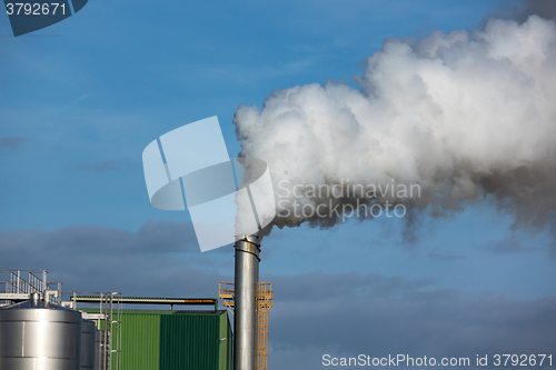 Image of Steaming Pipe on Blue Sky Background