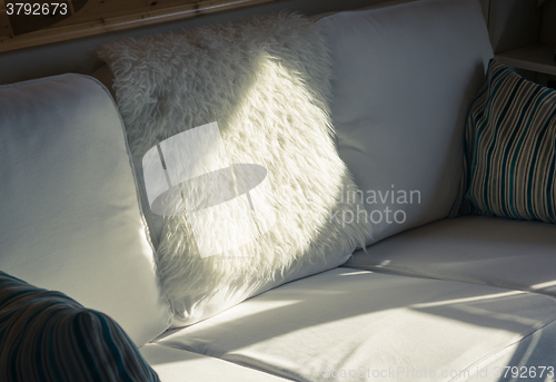 Image of Sunbeam Falls on a White Sofa