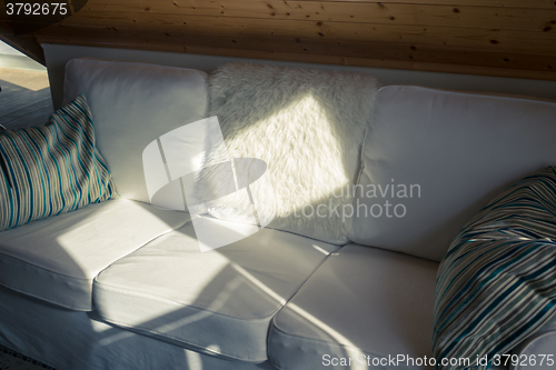 Image of Sunbeam Falls on a White Sofa