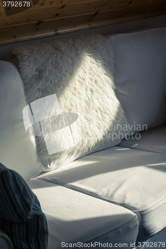 Image of Sunbeam Falls on a White Sofa