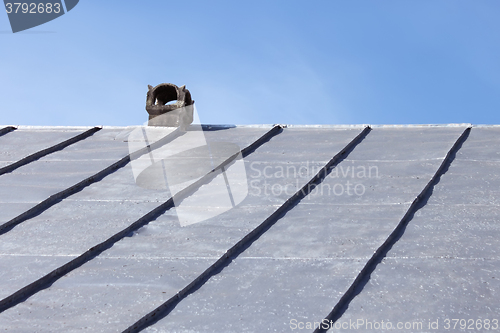 Image of Chimney on an old tinny roof