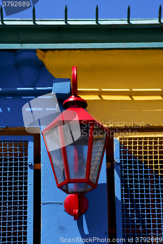 Image of   lamp  and a colorated  wall in la boca buenos aires 