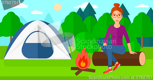 Image of Woman sitting at camp.