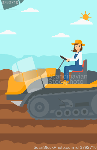 Image of Farmer driving catepillar tractor.