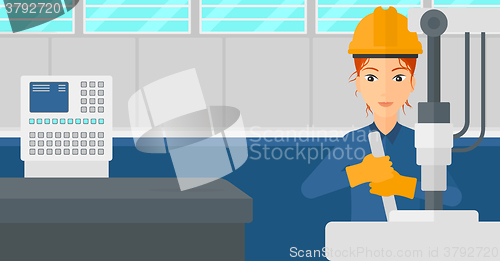 Image of Woman working with industrial equipment.