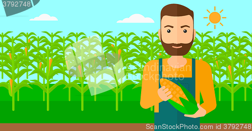 Image of Farmer holding corn.