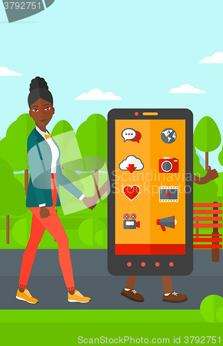 Image of Woman walking with smartphone.