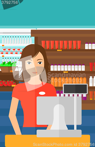 Image of Saleslady standing at checkout.