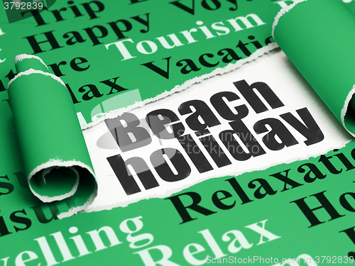 Image of Tourism concept: black text Beach Holiday under the piece of  torn paper