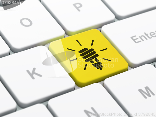 Image of Business concept: Energy Saving Lamp on computer keyboard background