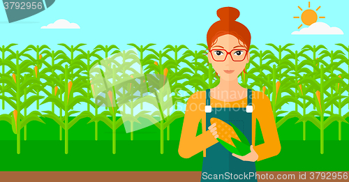 Image of Farmer holding corn.